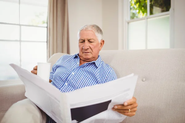 Senior man reading newspaper