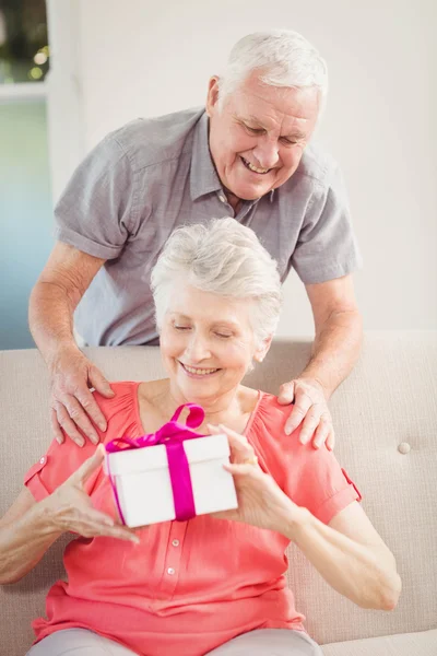 Man giving surprise gift to woman