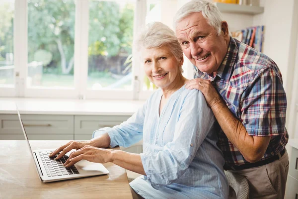 Portrait of senior couple using laptop