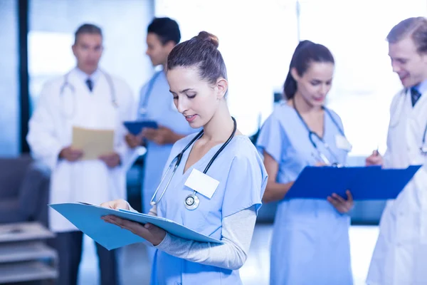 Female doctor checking medical report