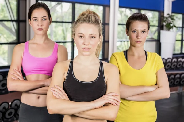 Serious women posing arms crossed