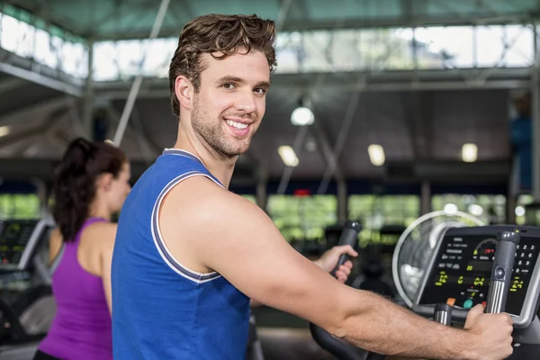 Fit man on elliptical bike