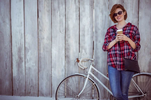 Woman with coffee and bicycle