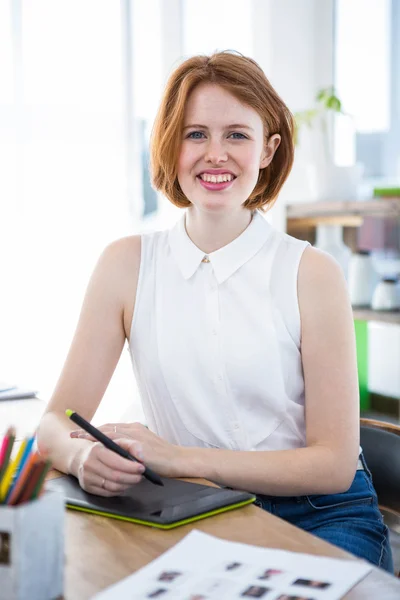 Hipster businesswoman writing on drawing tablet