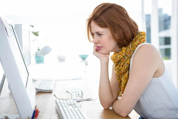 Thoughtful businesswoman concentrating on computer