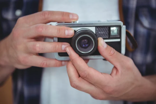 Masculine hands holding retro camera