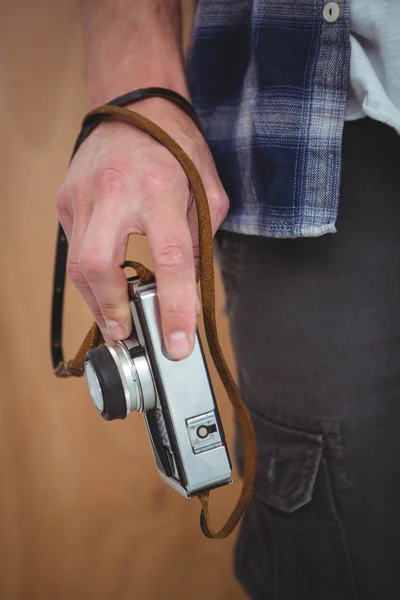 Masculine hands holding retro camera