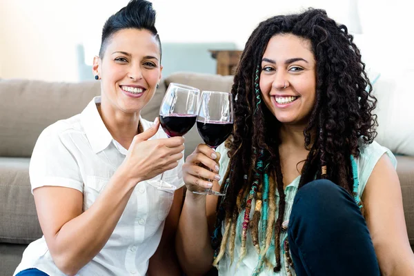 Lesbian couple toasting wine glasses