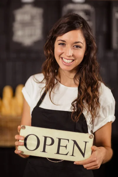 Waitress showing open sign