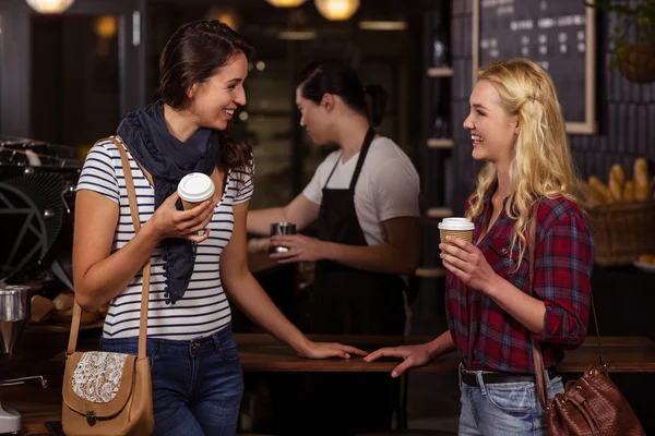 Smiling friends enjoying coffee