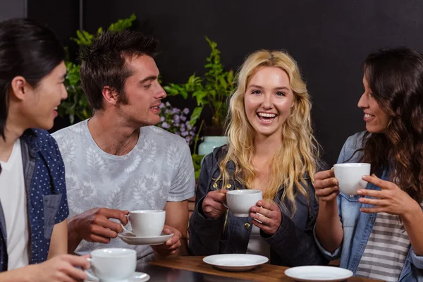 Friends talking and enjoying coffee