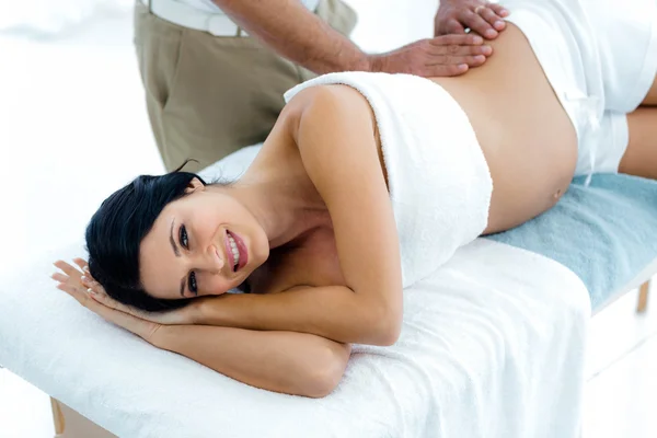 Pregnant woman receiving a back massage