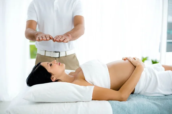 Pregnant woman receiving a spa treatment