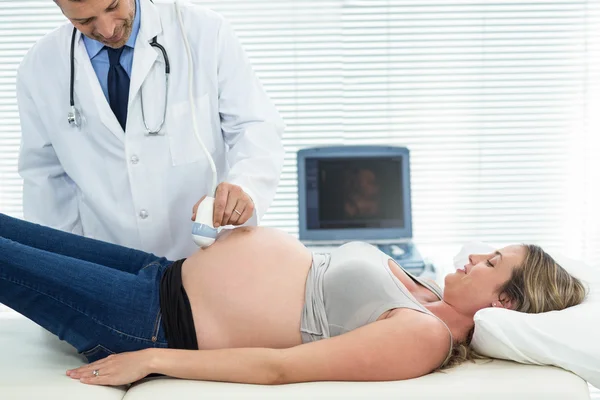 Pregnant woman receiving ultrasound treatment