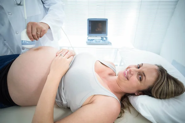 Pregnant woman receiving ultrasound treatment