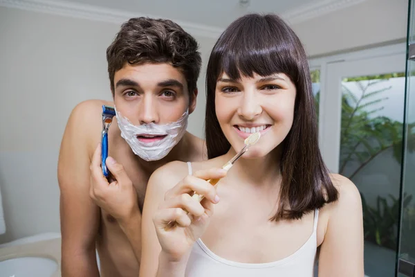 Bathroom routine for happy young couple
