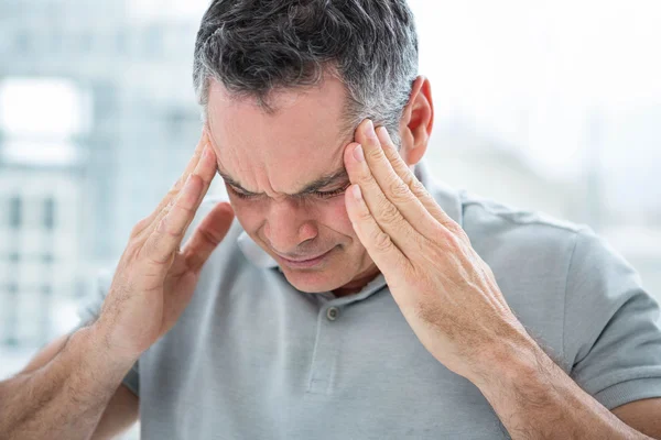 Tensed man touching his temples