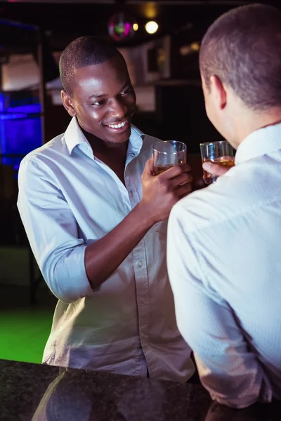 Two men toasting with glass of whiskey