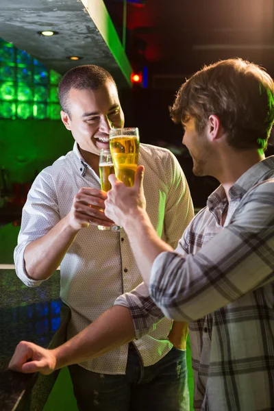Two men toasting with glass of beer