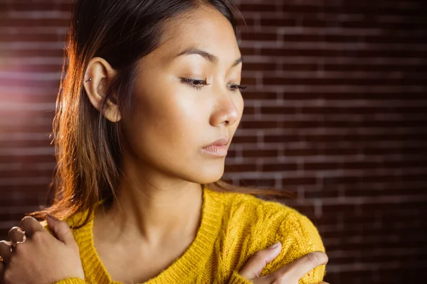 Serious asian woman looking down