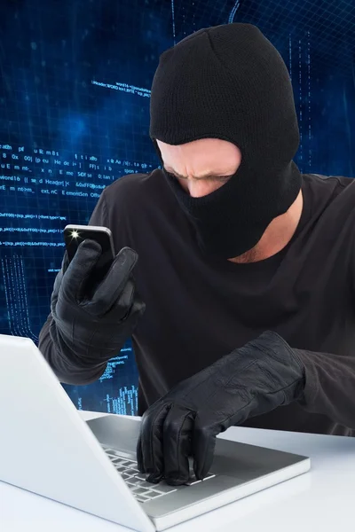 Thief taking picture document on laptop