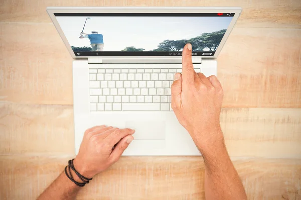 Hand pointing on blank laptop screen