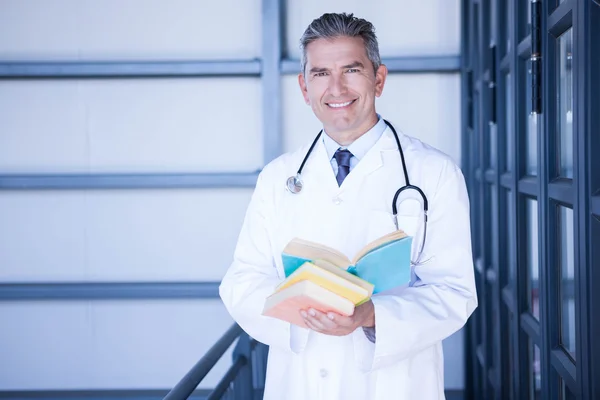Doctor standing with medical books