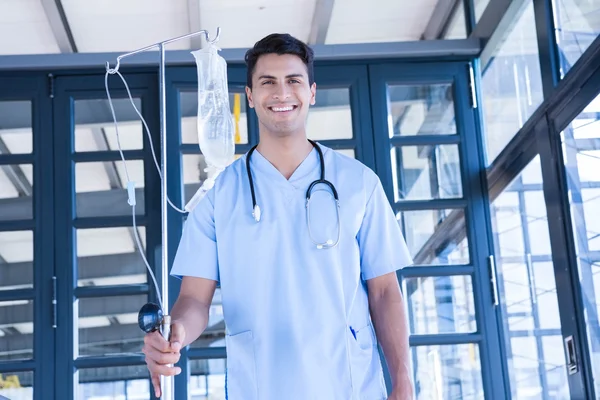 Doctor holding intravenous drip