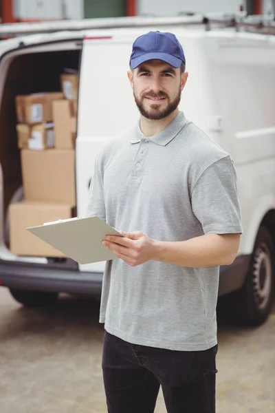 Delivery man holding clipboard