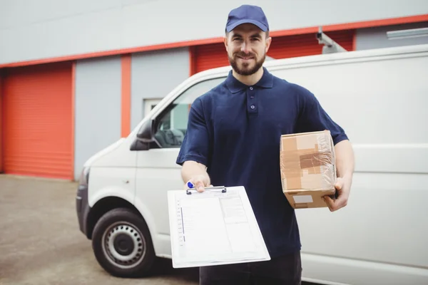 Delivery man holding clipboard