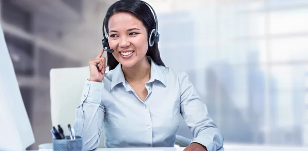 Smiling businesswoman using headset