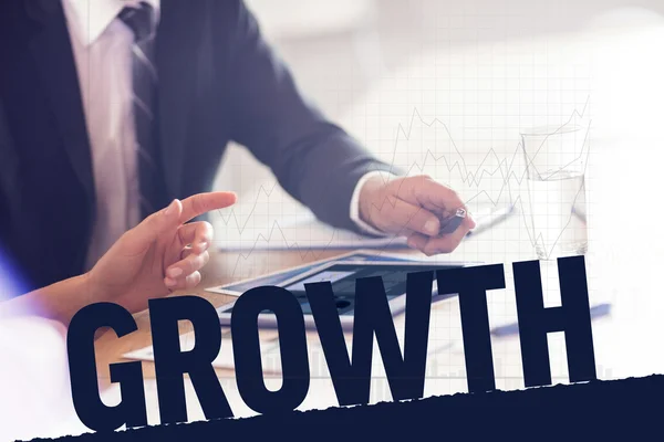 Growth against business people using tablet pc