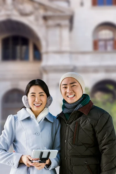 Cheerful couple against buildings