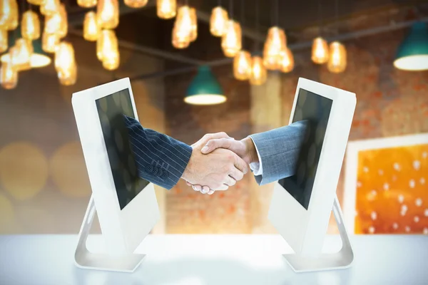 Composite image of business people shaking hands