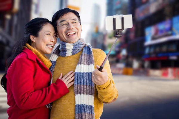 Older asian couple taking selfie