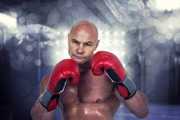 Bald boxer in red gloves