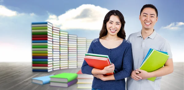 Happy couple holding books