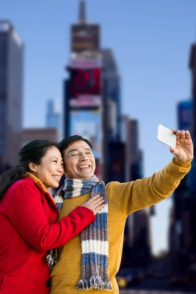 Asian couple taking selfie