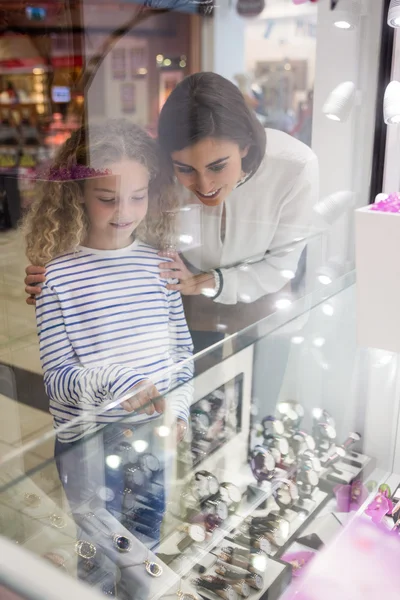 Mother and daughter selecting  watches in shop