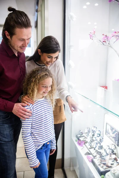 Happy family window shopping in mall