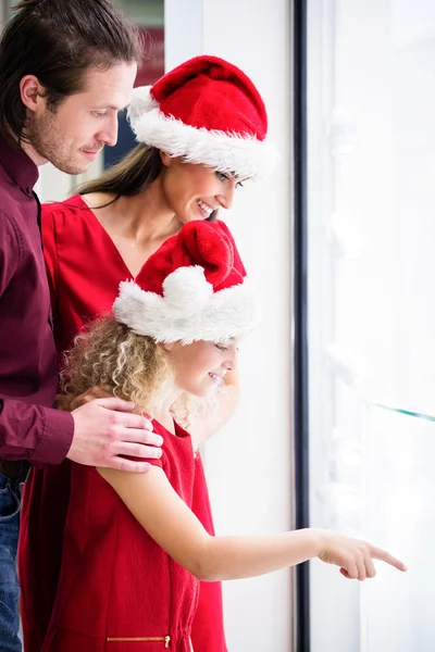 Family in Christmas attire in shop