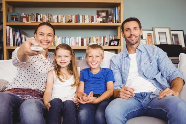 Smiling family watching television