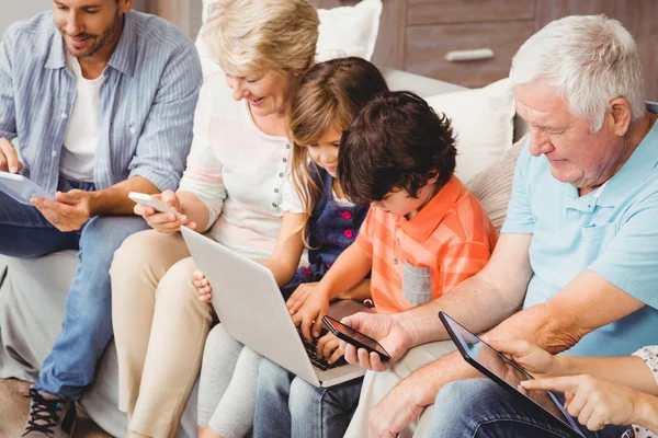 Family with grandparents using technology
