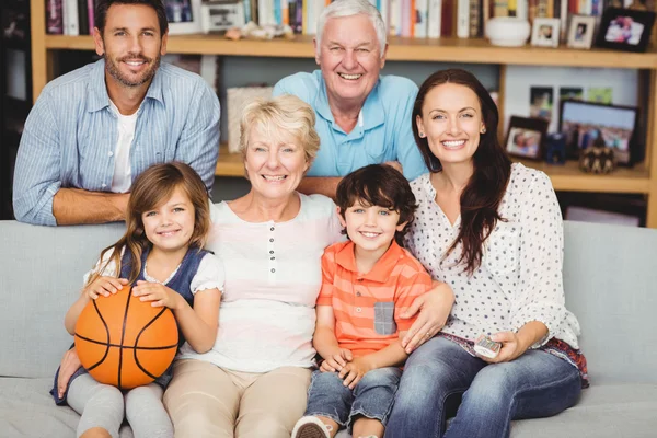 Smiling family watching basketball match