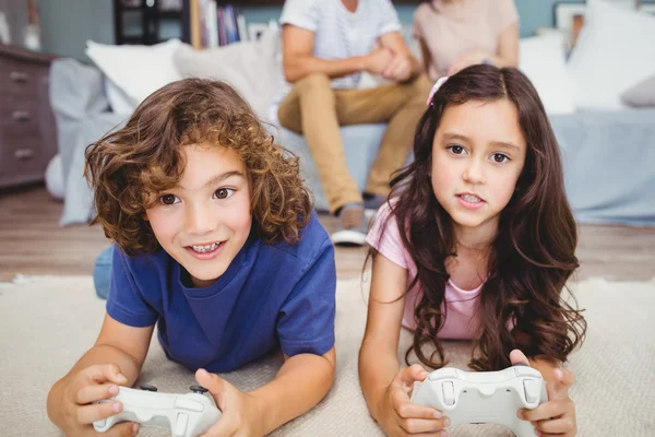 Siblings with remote playing video games