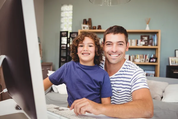 Father and son using computer