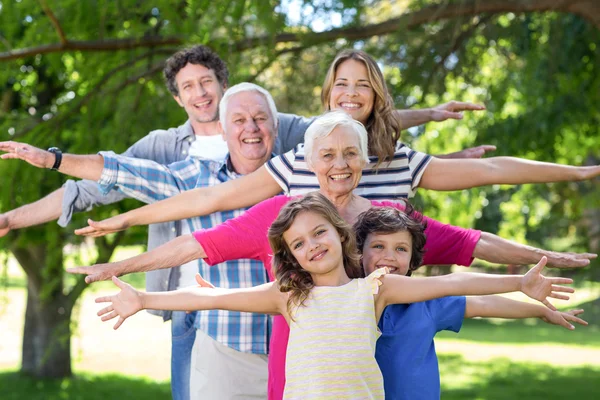 Family standing with arms stretched out
