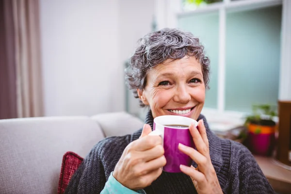 Woman drinking coffee at home