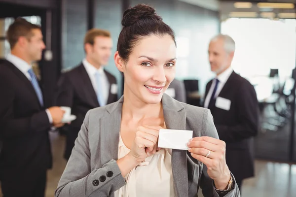 Businesswoman showing badge