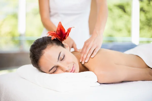 Woman receiving massage at health spa